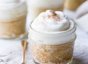 Tres leches cake baked in a small jar, topped with whipped cream.