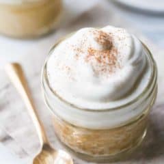 Tres leches cake baked in a jar with a gold spoon and a linen napkin.