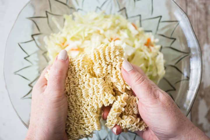 Breaking up ramen noodles to add to ramen salad.