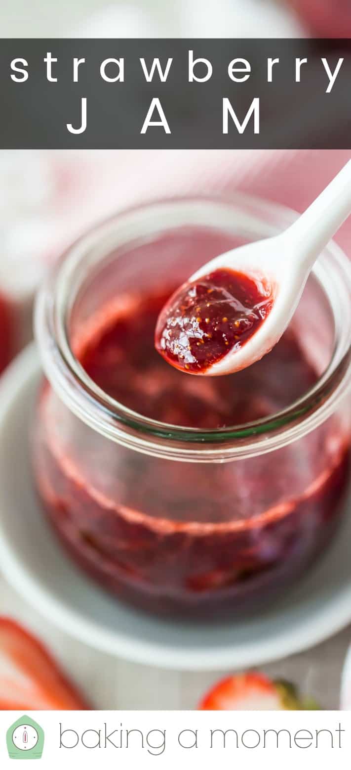 Small jar of homemade strawberry jam, with a white ceramic spoon and a text overlay reading "Strawberry Jam."