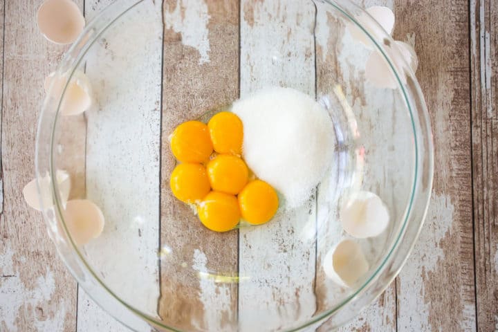 Egg yolks, sugar, and salt in a large glass bowl.