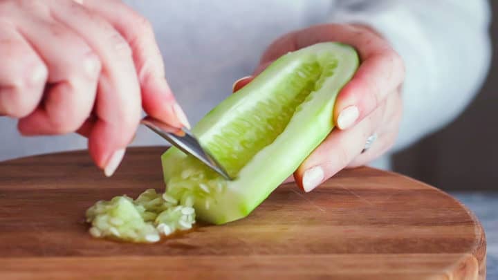 Removing seeds from a fresh cucumber.