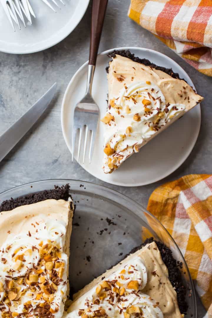 Overhead image of a slice of easy peanut butter pie with an orange checked cloth.