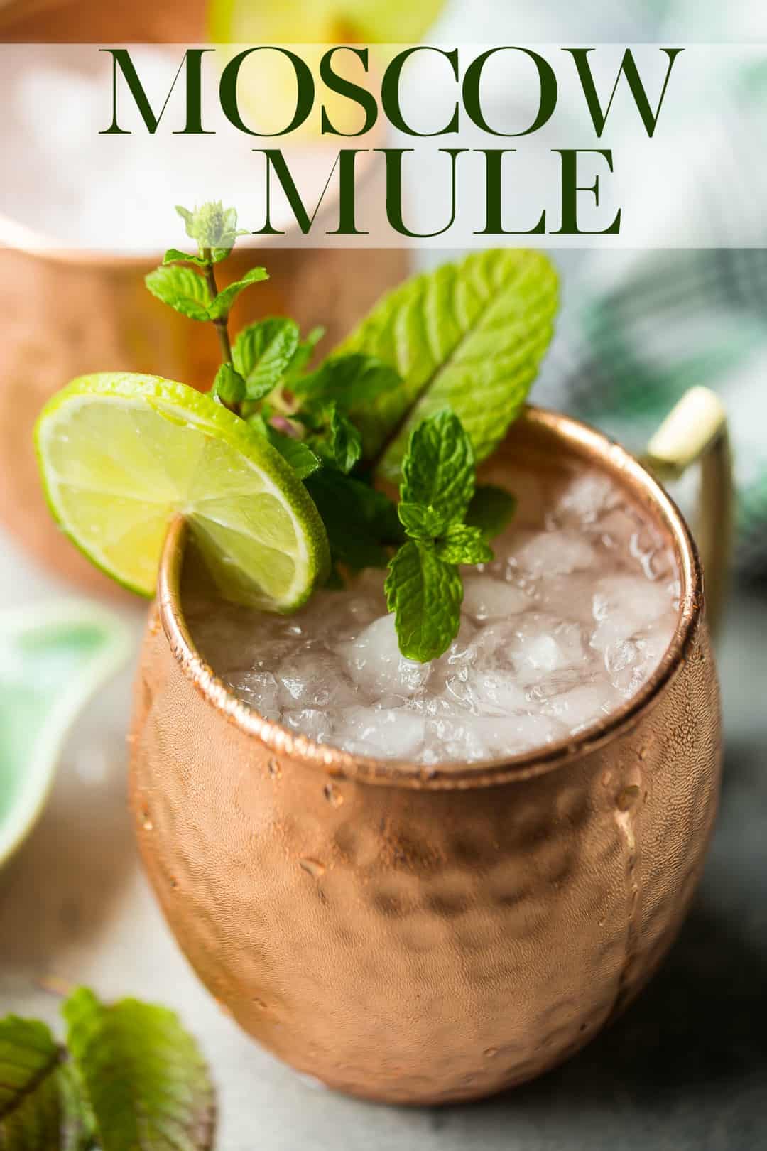 Moscow mule cocktail in a copper mug with a text overlay above that reads "Moscow Mule."