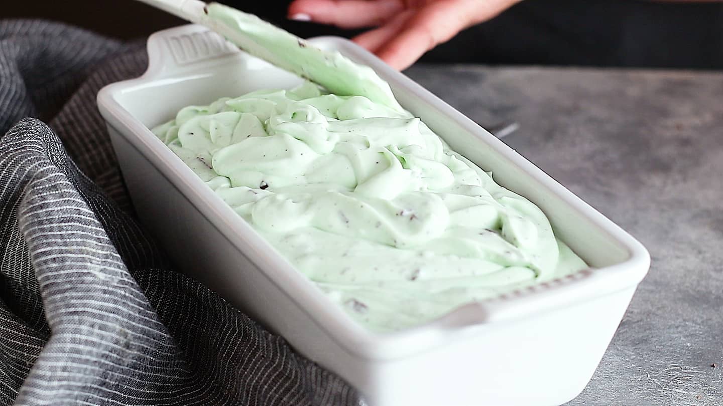 Mint chocolate chip ice cream base in a white loaf pan.