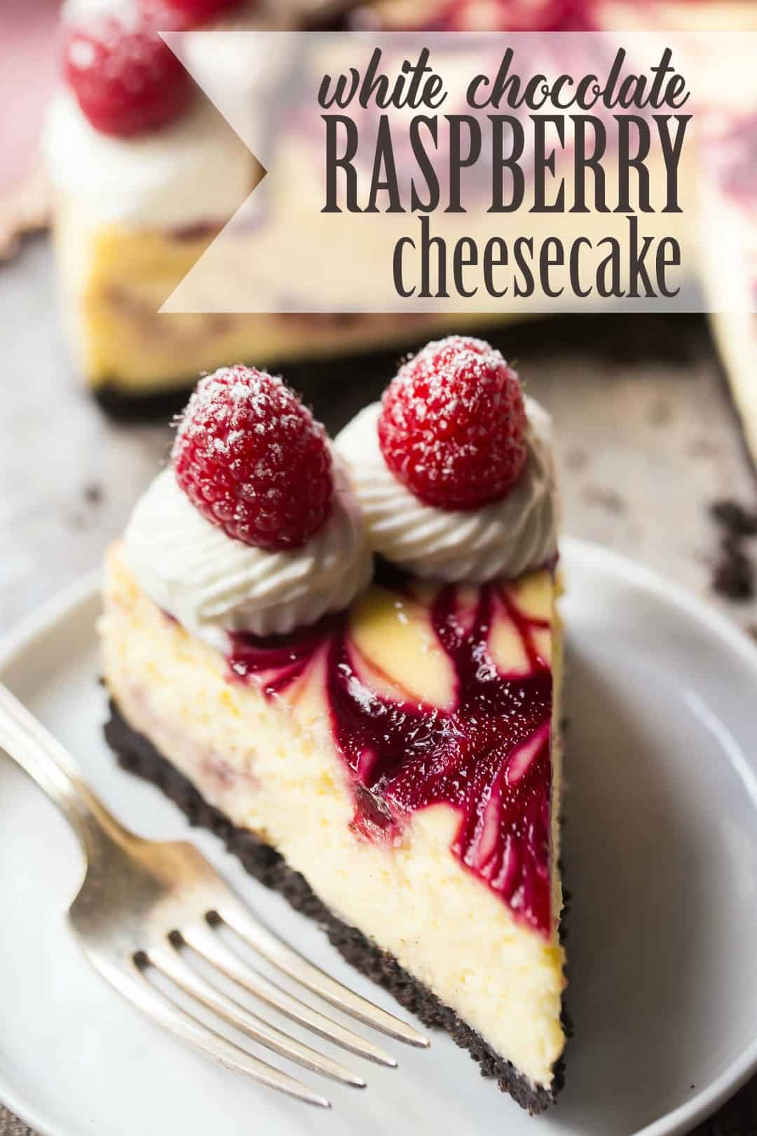 Slice of white chocolate raspberry truffle cheesecake with a text overlay above reading "White Chocolate Raspberry Cheesecake."