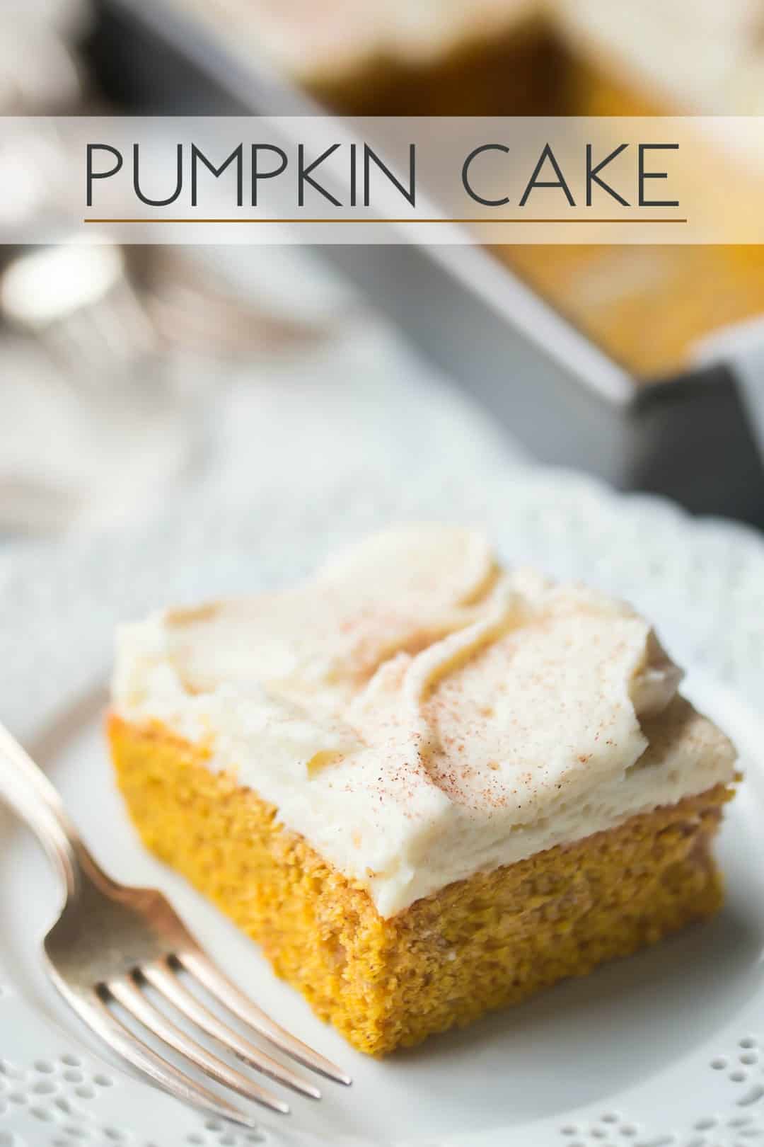 Square of pumpkin cake with cream cheese icing on a white plate, with a text overlay above that reads "Pumpkin Cake."