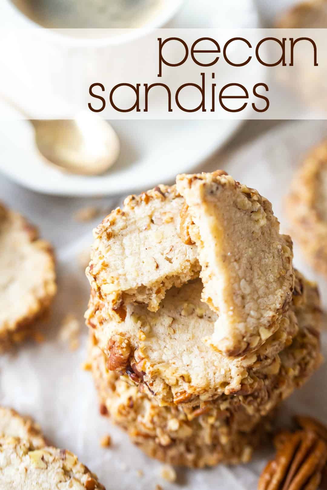 Close up image of a stack of homemade pecan sandies recipe with a text overlay above reading "Pecan Sandies."
