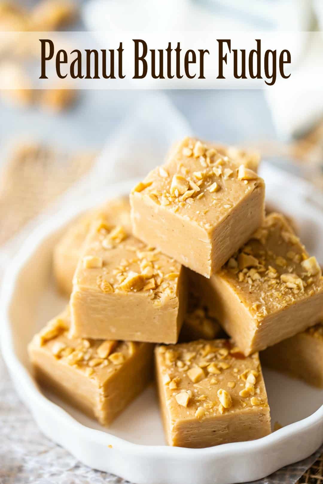 Easy peanut butter fudge cut into squares and presented in a white dish, with a text overlay above reading "Peanut Butter Fudge."