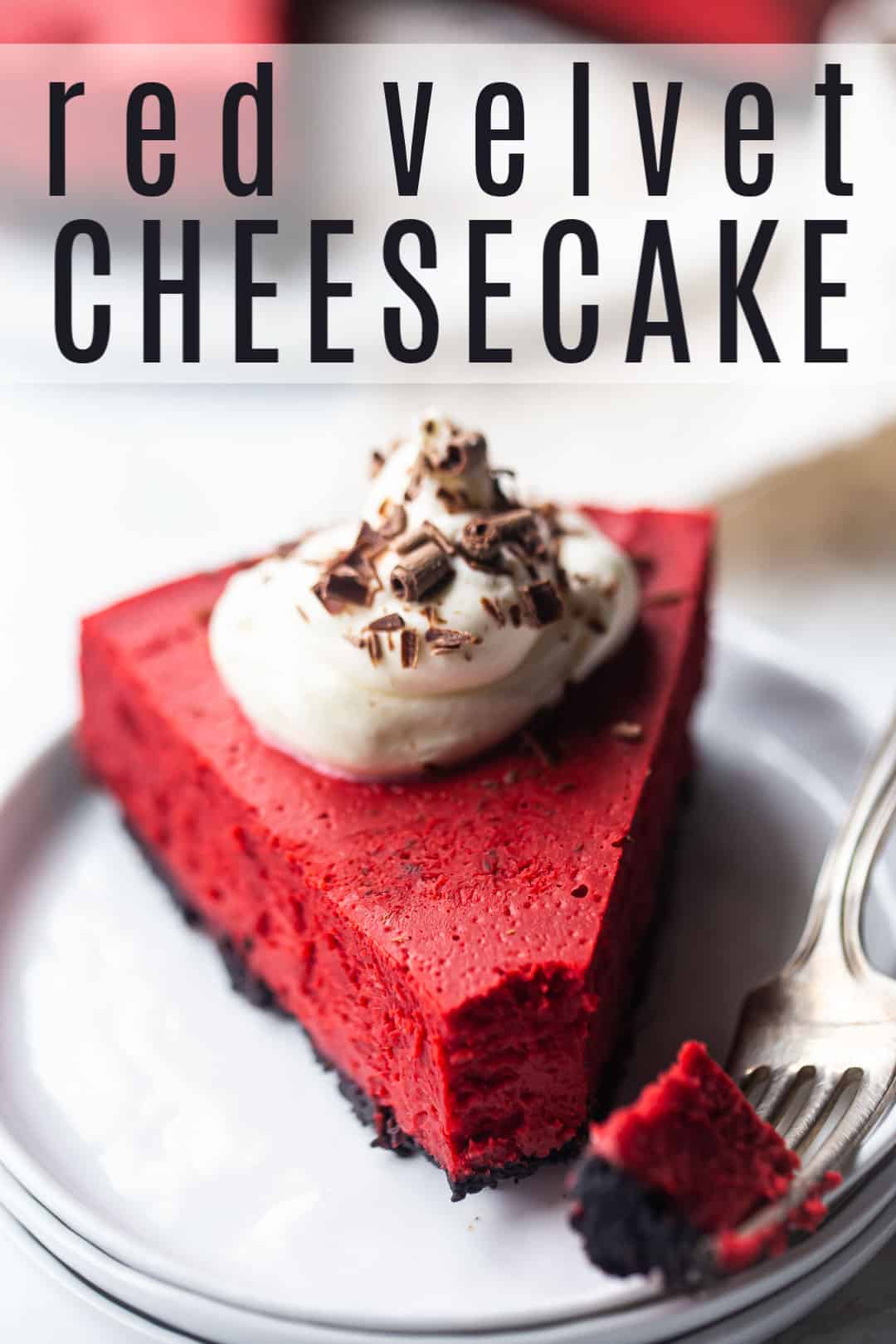 Red velvet cheesecake recipe, baked and served on a white plate, with a text overlay above that reads "Red Velvet Cheesecake."