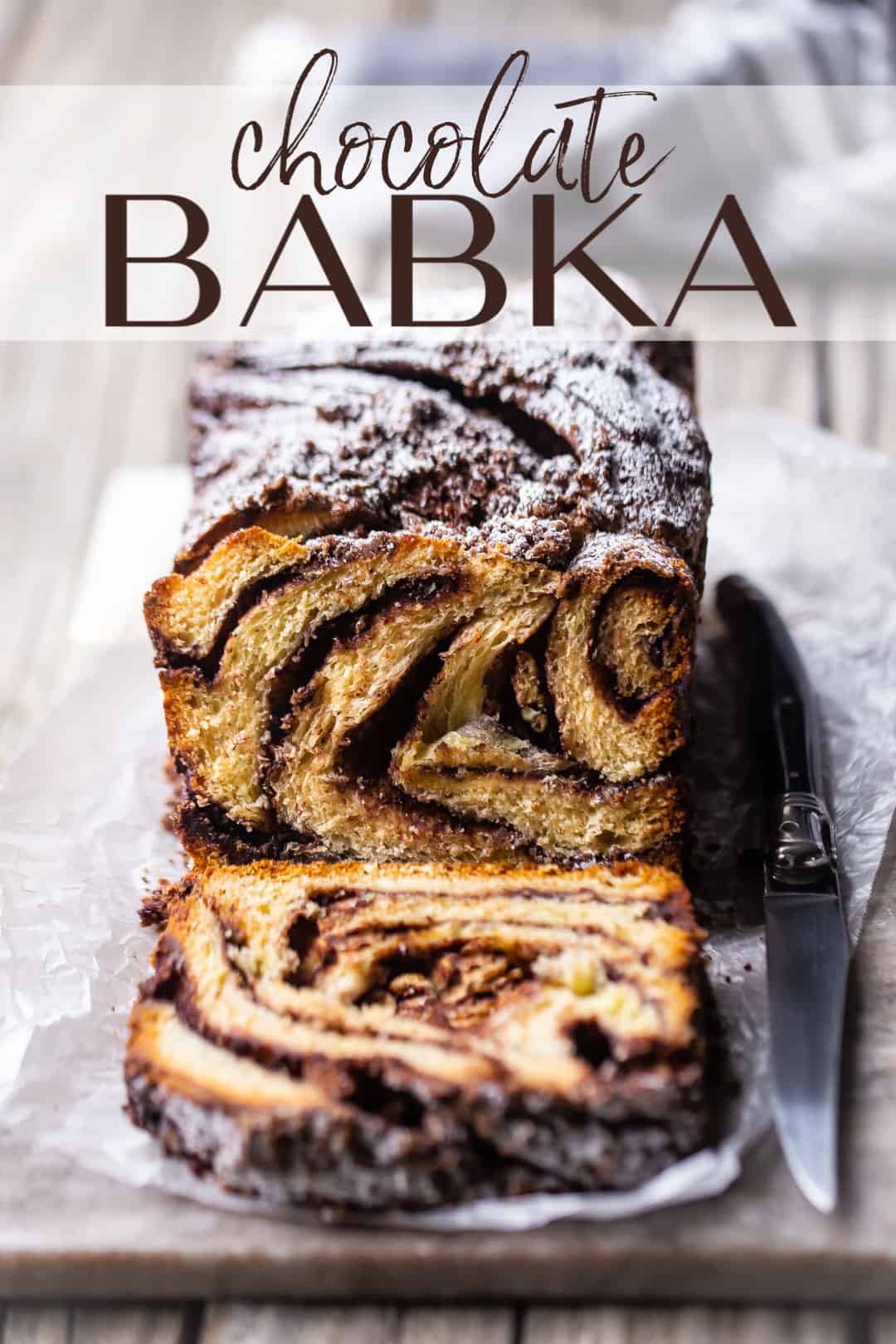 Chocolate babka recipe, prepared, sliced, and served on a marble board, with a text overlay above that reads "Chocolate Babka."