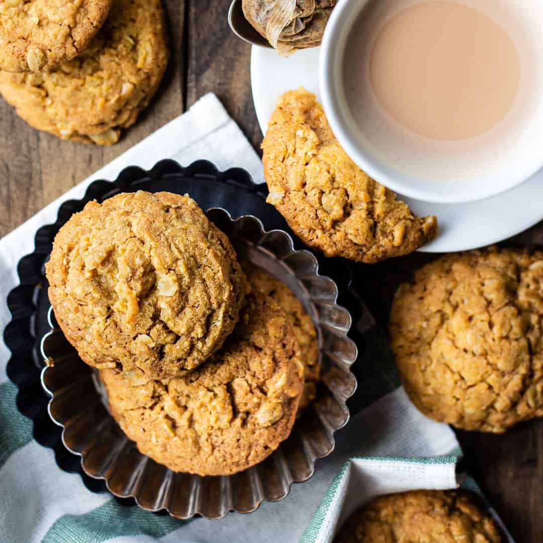 Irish oat cookies in a fluted pan with a cup of tea.