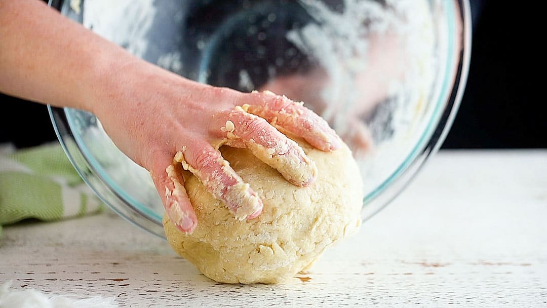 Transferring Irish scone dough to a lightly floured work surface.