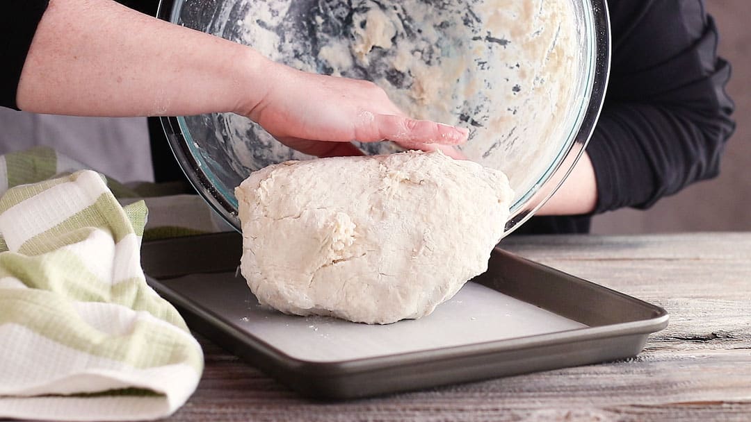 Transferring Irish soda bread dough to a baking sheet.
