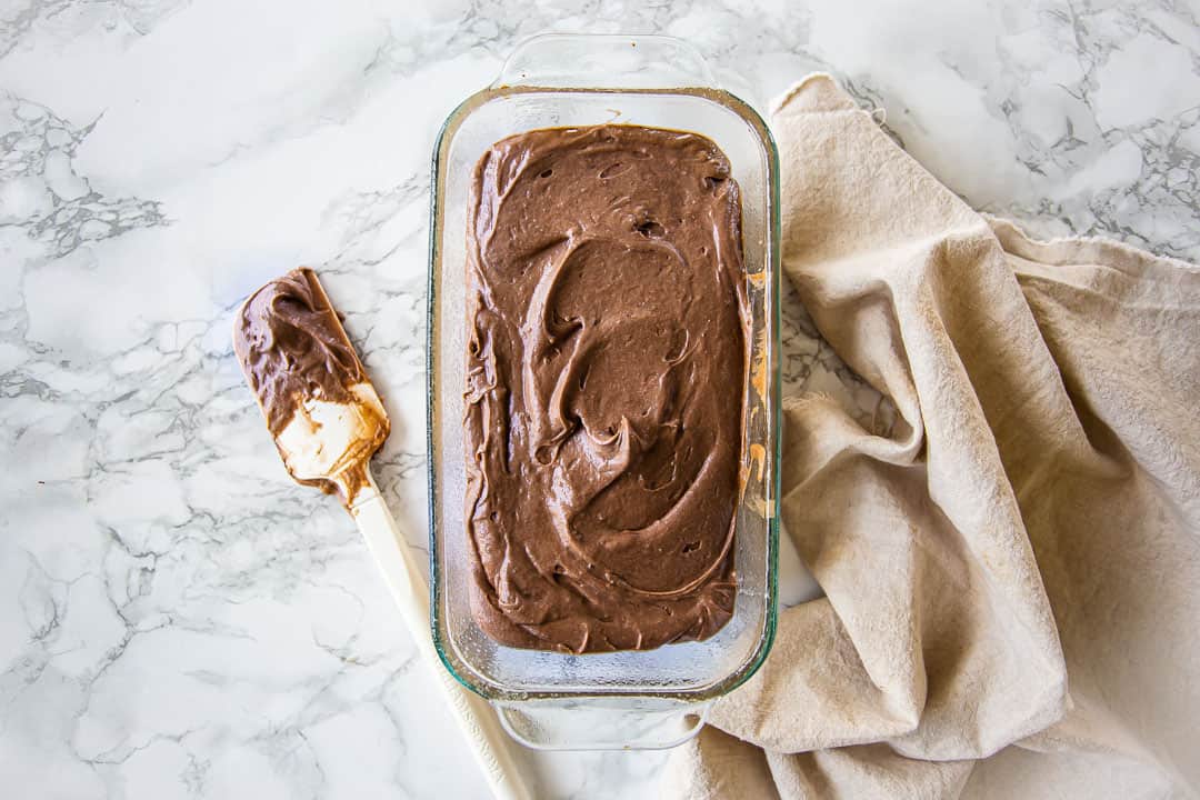 Chocolate pound cake batter in a loaf pan.
