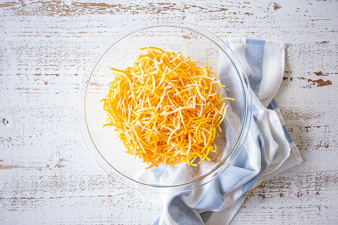 Shredded cheese blend in a large glass bowl.