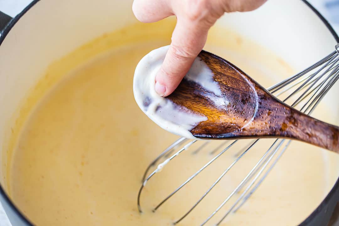 Thickened bechamel sauce coating the back of a spoon.