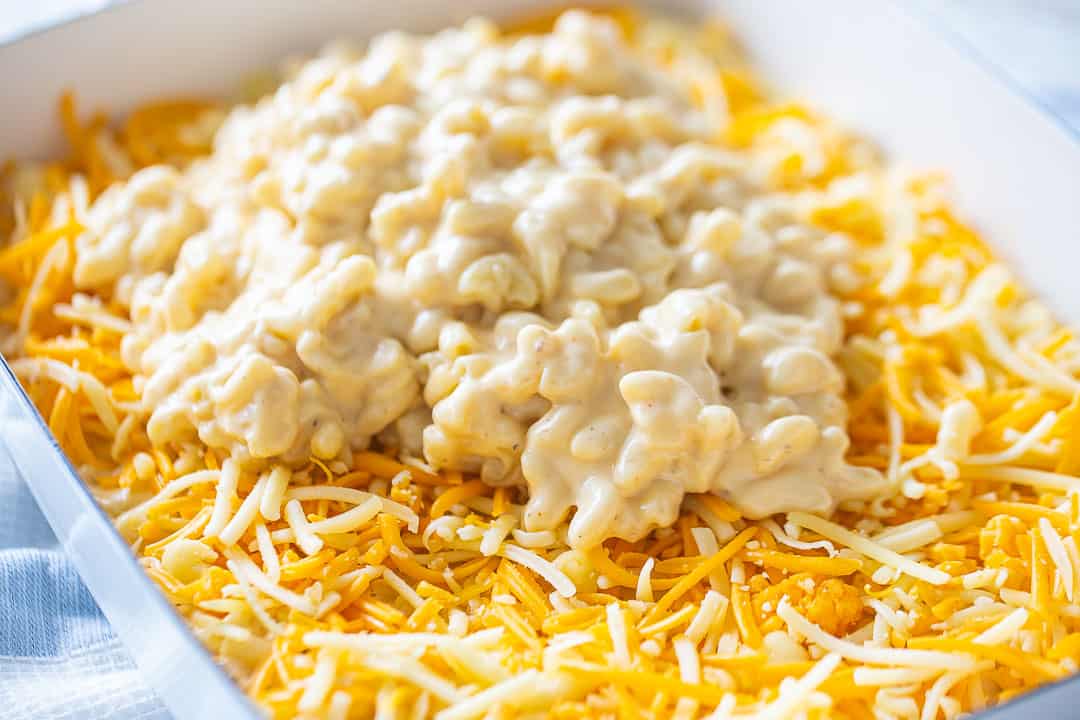 Mac n cheese layers of noodles and cheese in a casserole.