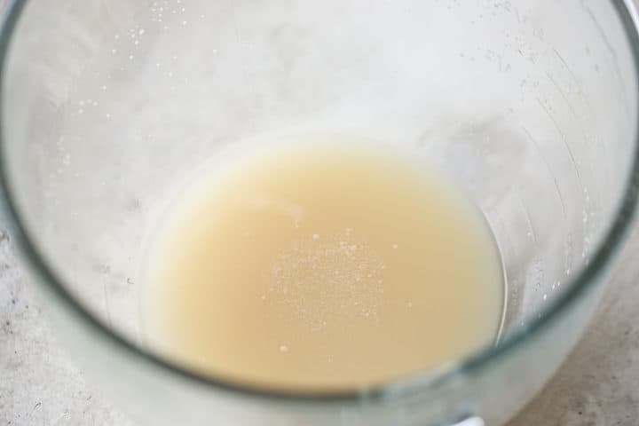 Dissolved yeast foaming in a glass mixing bowl.
