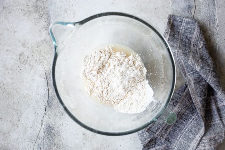 Adding all-purpose flour to bagel recipe.