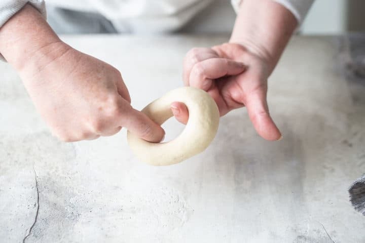Shaping homemade bagels by hand.