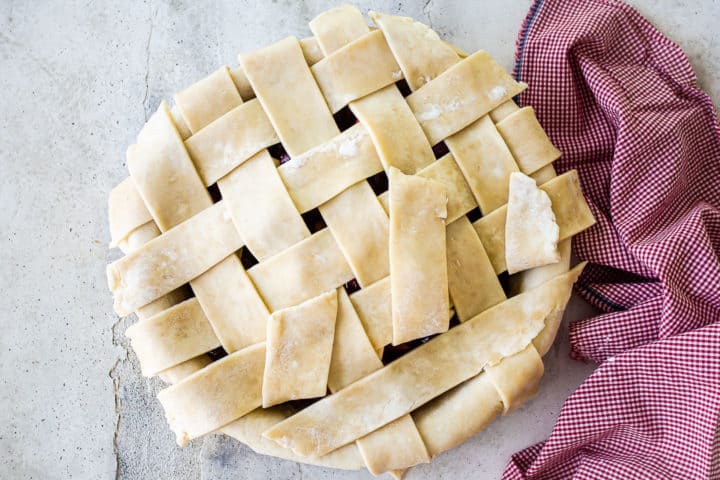 Creating a lattice top on homemade cherry pie.