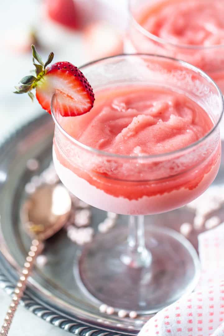 Wine slushies in crystal glasses with fresh strawberries.