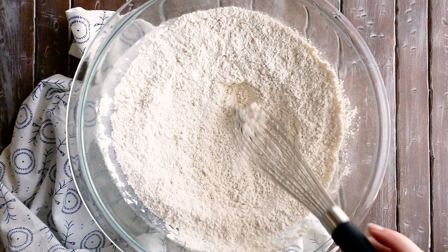 Whisking flour and salt together in a large bowl.