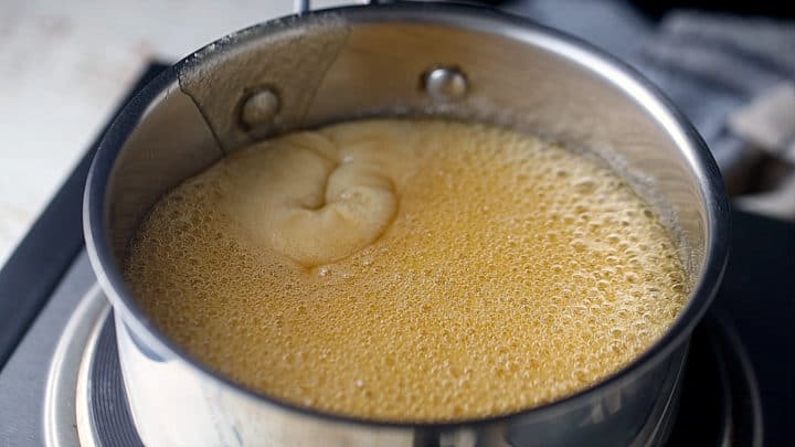 Boiling honey and sugar together.