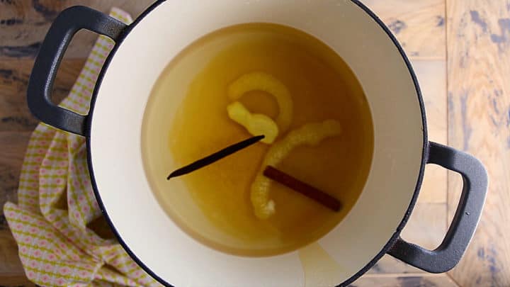 Overhead view of poaching liquid in a large pot.