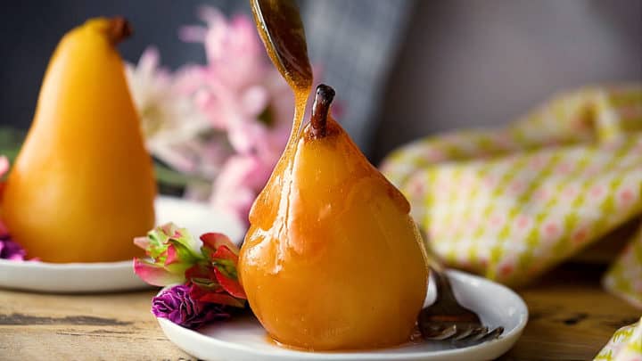 Drizzling reduced syrup over poached pears.