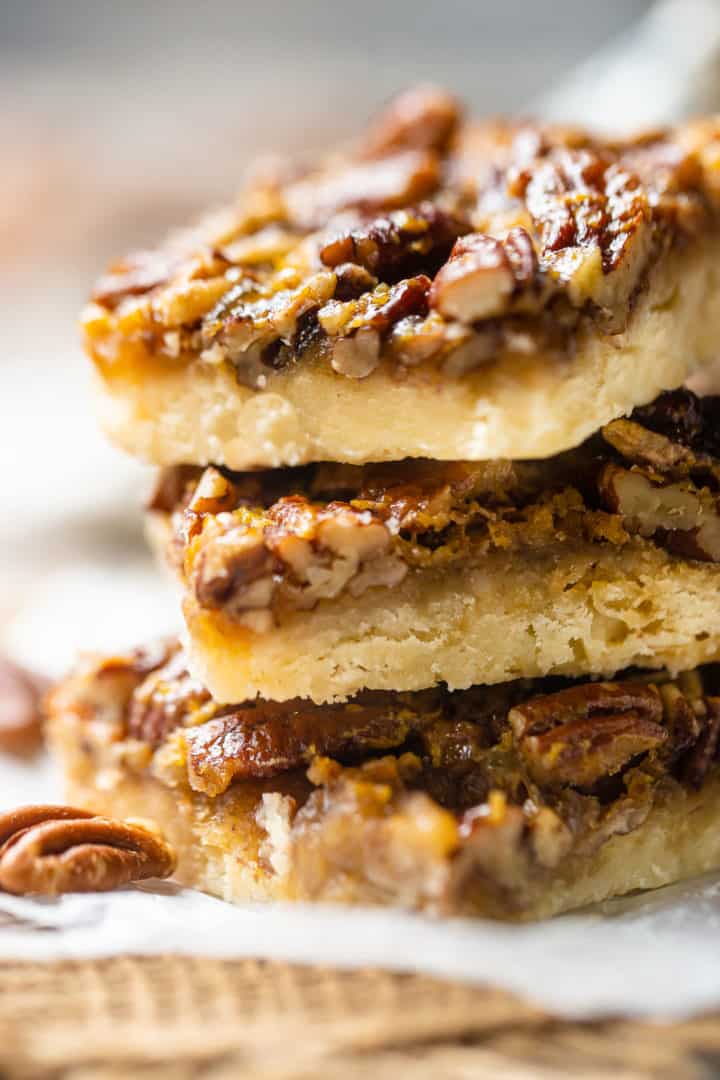 Close-up image of a stack of pecan pie squares.