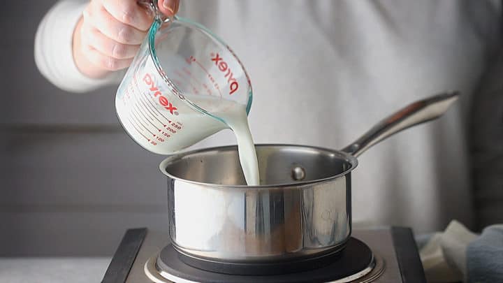 Warming milk and cream in a small pot.