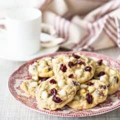 Oatmeal cranberry cookies on a vintage red and white plate.