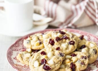 Oatmeal cranberry cookies on a vintage red and white plate.