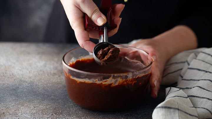 Scooping ganache to make chocolate truffles.