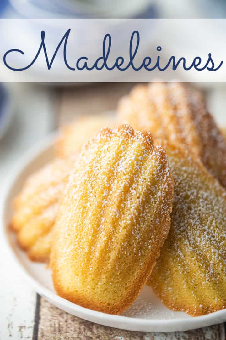 Madeleine cookie recipe, made in the traditional seashell shape, with a text overlay above that reads "Madeleines."