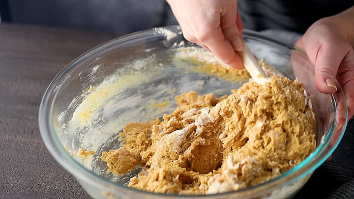Folding dry ingredients into dough.
