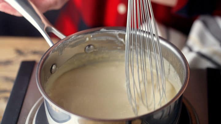 Whisking cream cheese and beer together.