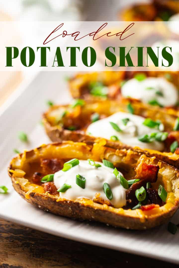 Potato skins recipe prepared and served with sour cream and sliced green onions.