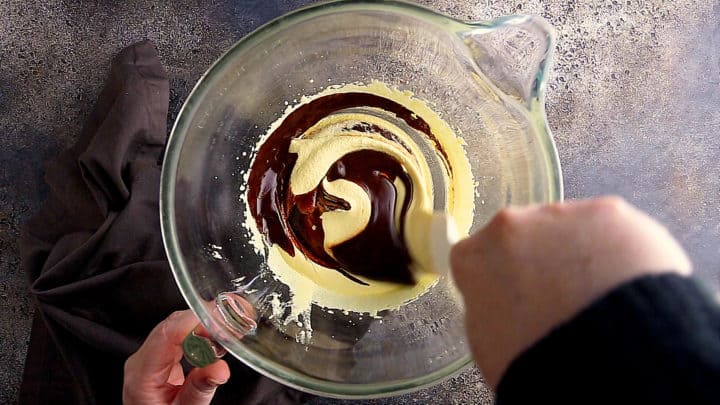Folding chocolate mixture into egg yolk mixture.