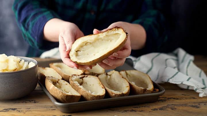Baked potatoes, halved lengthwise and scooped out.