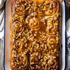 sticky buns on serving tray topped with nuts
