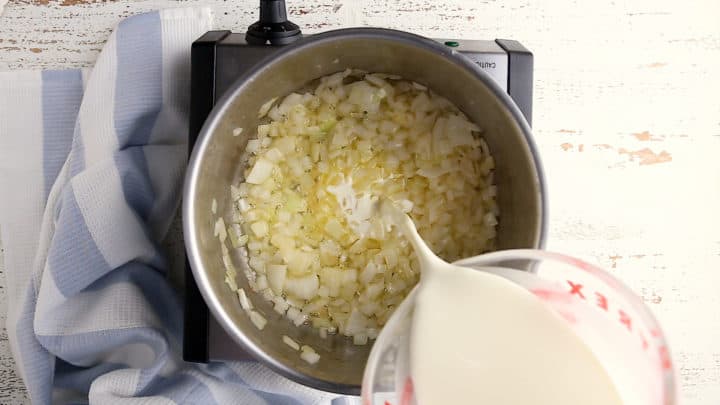 Sauteing onions and adding cream and milk.