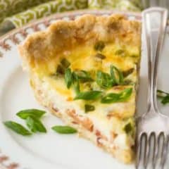 slice of quiche lorraine on plate with fork