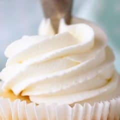 whipped cream frosting piped onto cupcake