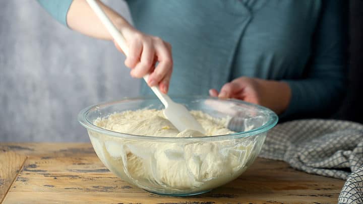 Folding the dough over onto itself.
