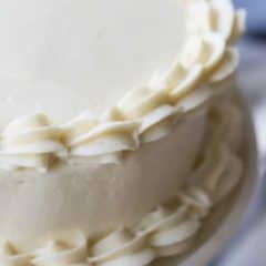 cream cheese frosted cake with piping