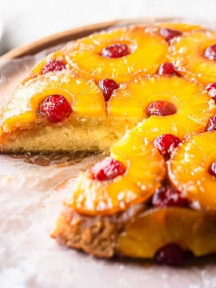 Pineapple upside-down cake on cake stand.