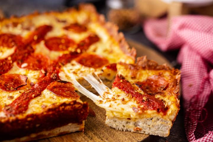 Close-up image of Detroit-style pizza Pizza Hut recipe highlighting thick, pillowy crust and stretchy melted cheese.